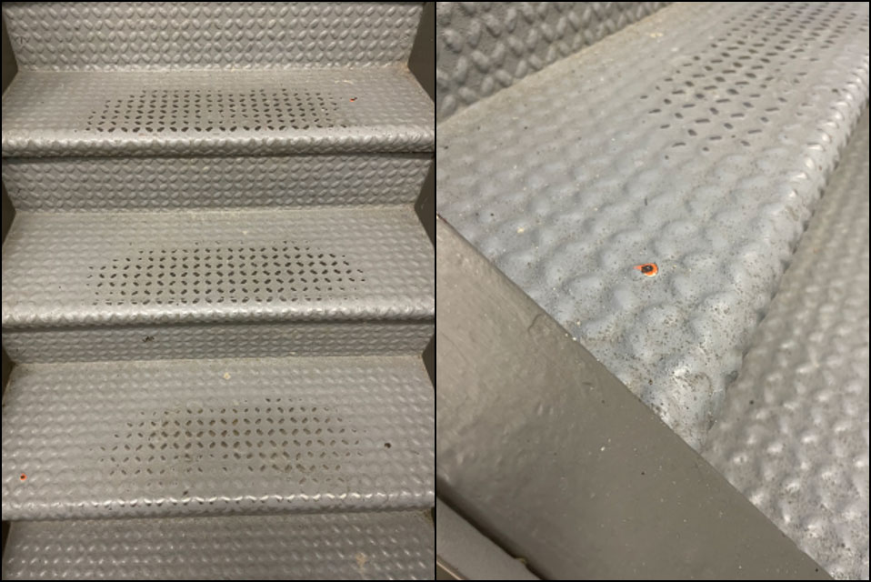 Gray metal stairs with chipped spots revealing previous orange paint.