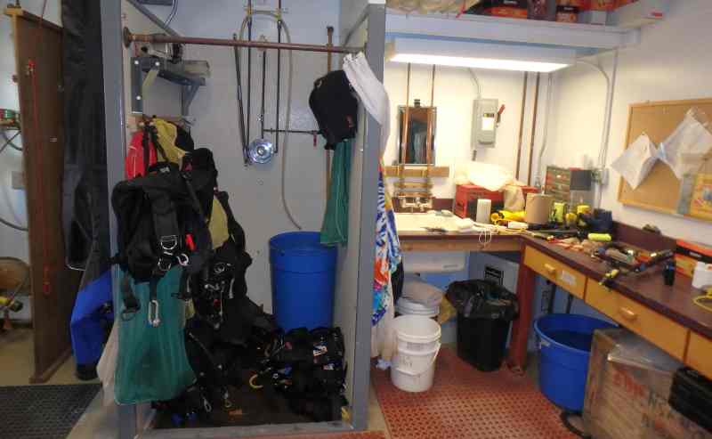 The dive locker shower with gear that has been drying overnight.