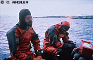 Photo by Charles D. Amsler Photo. Chuck Amsler (left) and Jack Baldelli between dives. In zodiac in Arthur Harbor off Palmer Station.