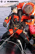 Bill Baker helps Katrin Iken with her dry suit, a key to survival in Antarctic waters. By Joanna Hubbard.
