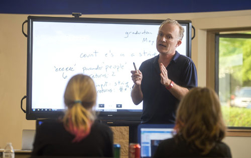 Dr. Johnstone teaching in a classroom. 