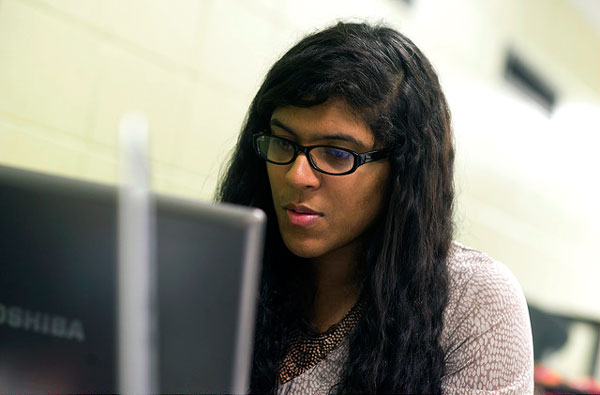 Female student in glasses at a laptop. 