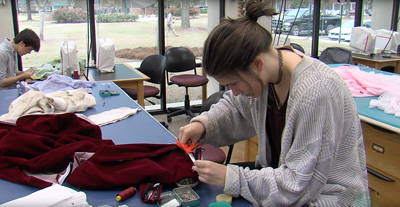 Student working with fabric in UAB Costume Studio