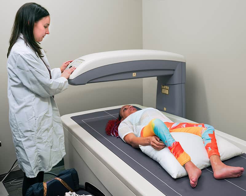 Patient is scanned using the DXA tool. 