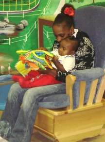 Kenyatta reading to baby