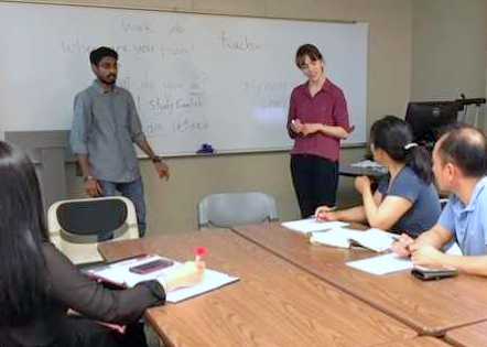 Parth Purohit and Charlotte Steiner teaching students in UAB's Community English Program