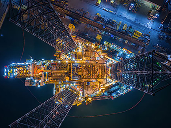 Oil rig at night, photographed from above. 