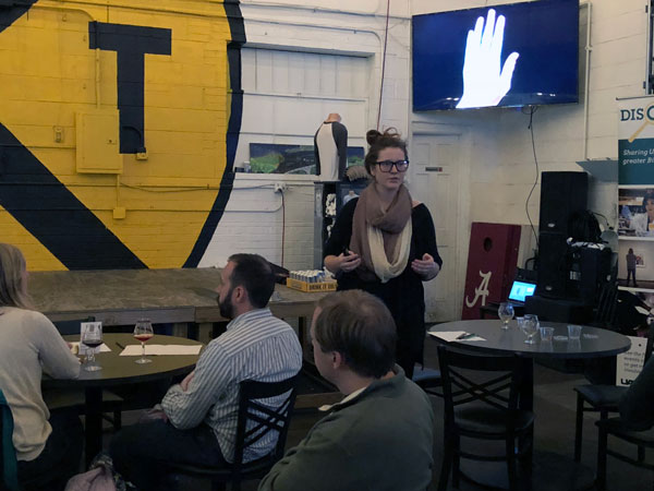 Sarah Adkins speaking to an audience at Ghost Train Brewing.
