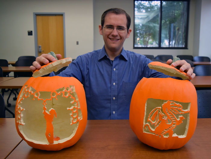 Michael Schultz with two carved pumpkins.