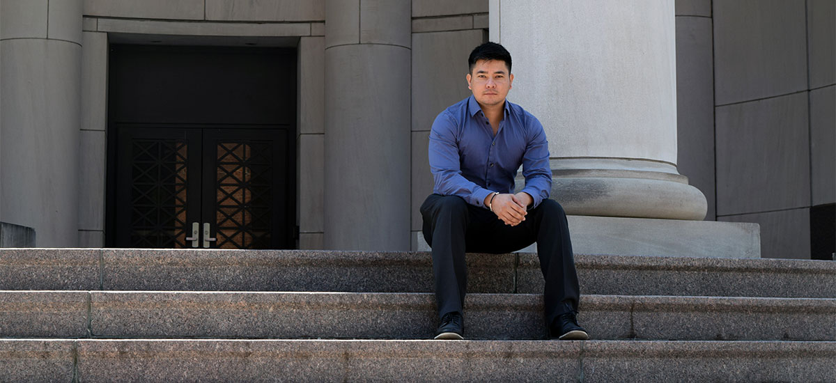 Samir Rana sitting on the steps of the Shelby Biomedical Research Building.