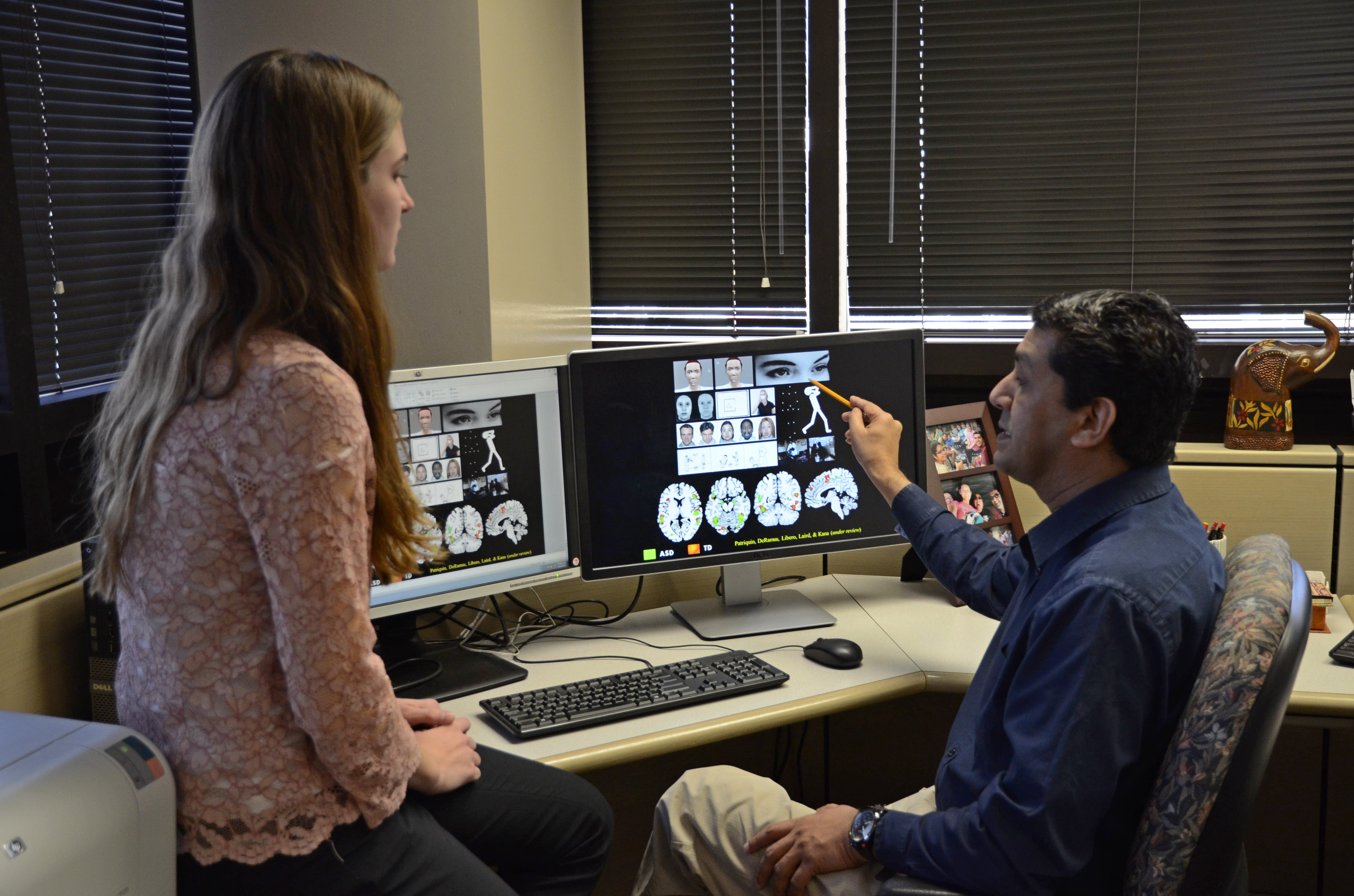 Dr. Rajesh Kana and student explore data on autism research.
