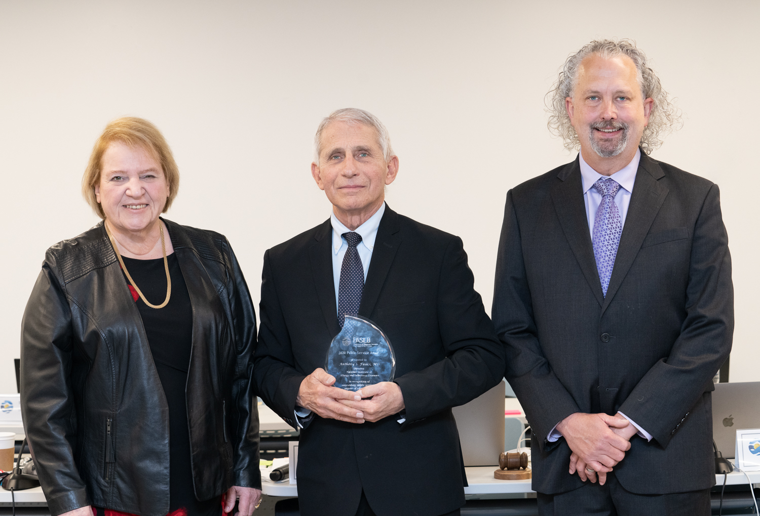 FASEB President Patricia Morris and Past President Louis Justement present the 2020 FASEB Public Service Award to Anthony Fauci.  
