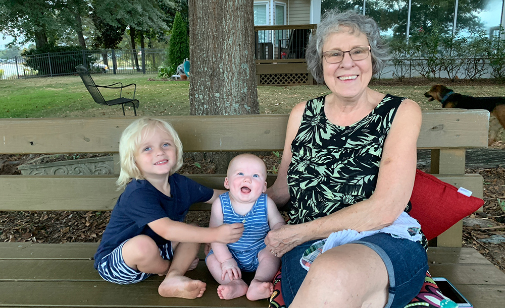 Norine Wilson plays with her grandchildren in the yard, an activity she is now able to do after receiving spine surgery from UAB neurosurgeon Dr. Mamerhi Okor in June 2017. (Photo courtesy of Norine Wilson)