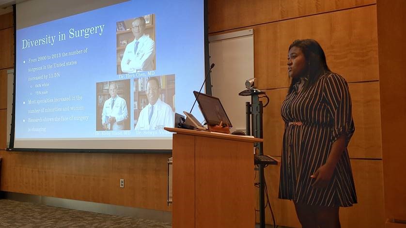 Alabama School of Fine Arts and UAB PRISM student Oluwatosin Badewa presents her research, "A Novel Application of Artificial Intelligence to Assess Diversity in Surgical Performance," under her mentor Colin Martin, MD and research manager Michelle Shroyer, MPH at the PRISM & SURE presentation reception in Wallace Tumor Institute 231 on Wednesday, July 24, 2019.  