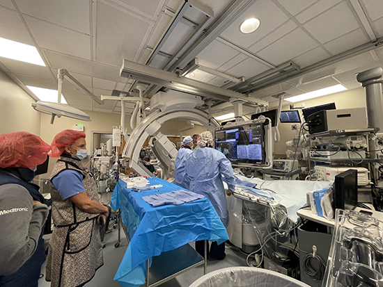 Surgeons in operating room looking at screen