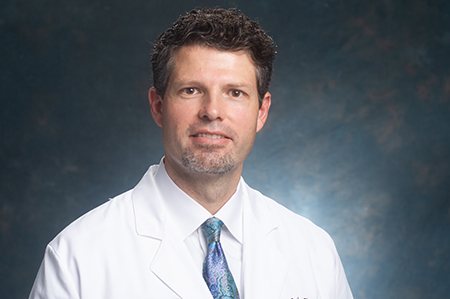 Head shot of Dr. Erik Hess, MD (Professor/Vice Chair for Research, Emergency Medicine) in white medical coat, 2018.