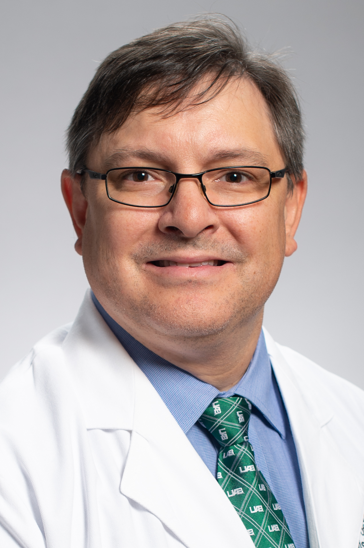 Headshot of Dr. C. Ryan Miller, MD, PhD (Professor, Neuropathology) in white medical coat, 2019.