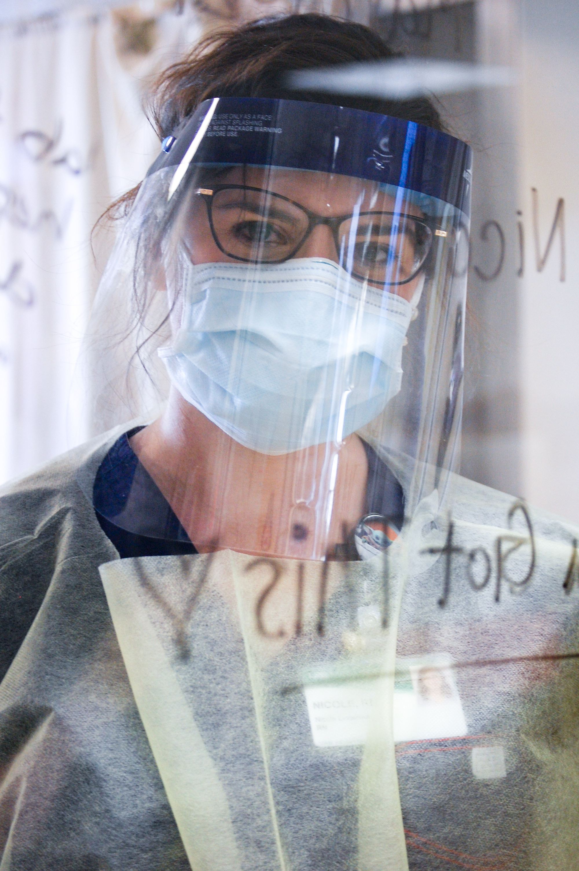 Female nurse is wearing Personal Protective Equipment (PPE) while working in the Hospital during the COVID-19 (Novel Coronavirus) pandemic, March 2020.
