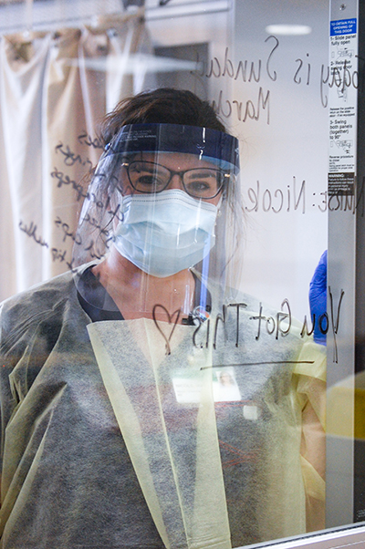 Female nurse is wearing Personal Protective Equipment (PPE) while working in the Hospital during the COVID-19 (Novel Coronavirus) pandemic, March 2020.