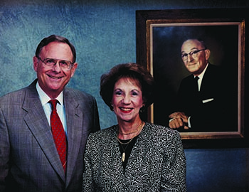Charles and Patsy Collat with a portrait of Mayer Electric Founder Ben Weil, Patsy's father