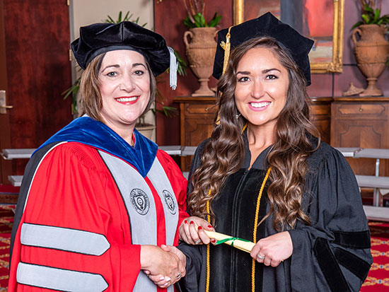 Hannah Greenfield, left, and School of Optometry Dean Nichols at graduation.