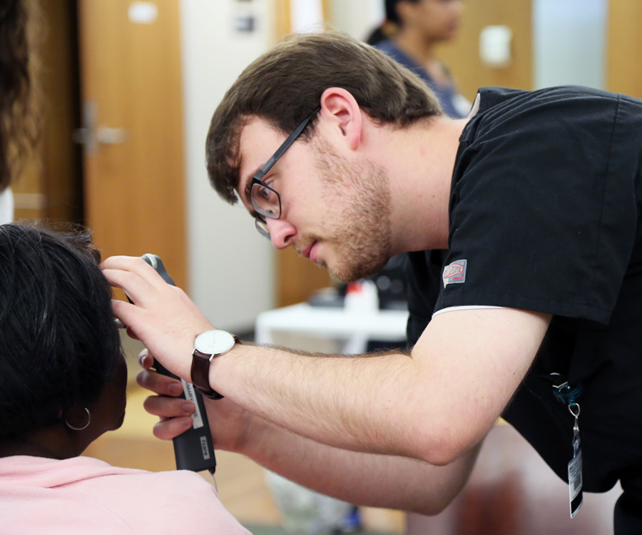 A student with the UAB School of Optometry examines a patient during the 2017 Gift of Sight event. Altogether, 260 patients received free eye care over four days.