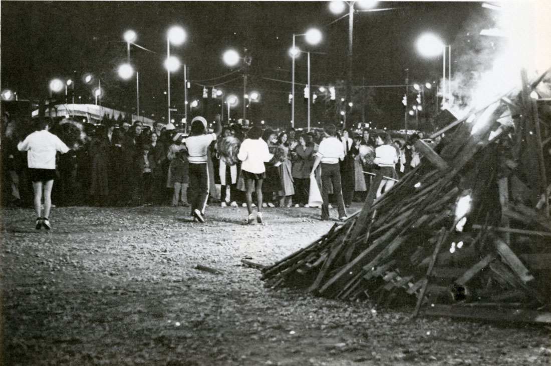 Photo of bonfire and cheerleaders with students