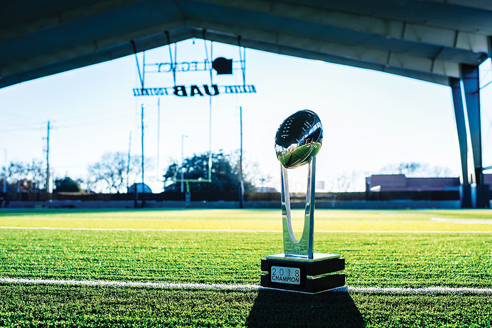Photo of Conference USA trophy on Legacy Pavilion field