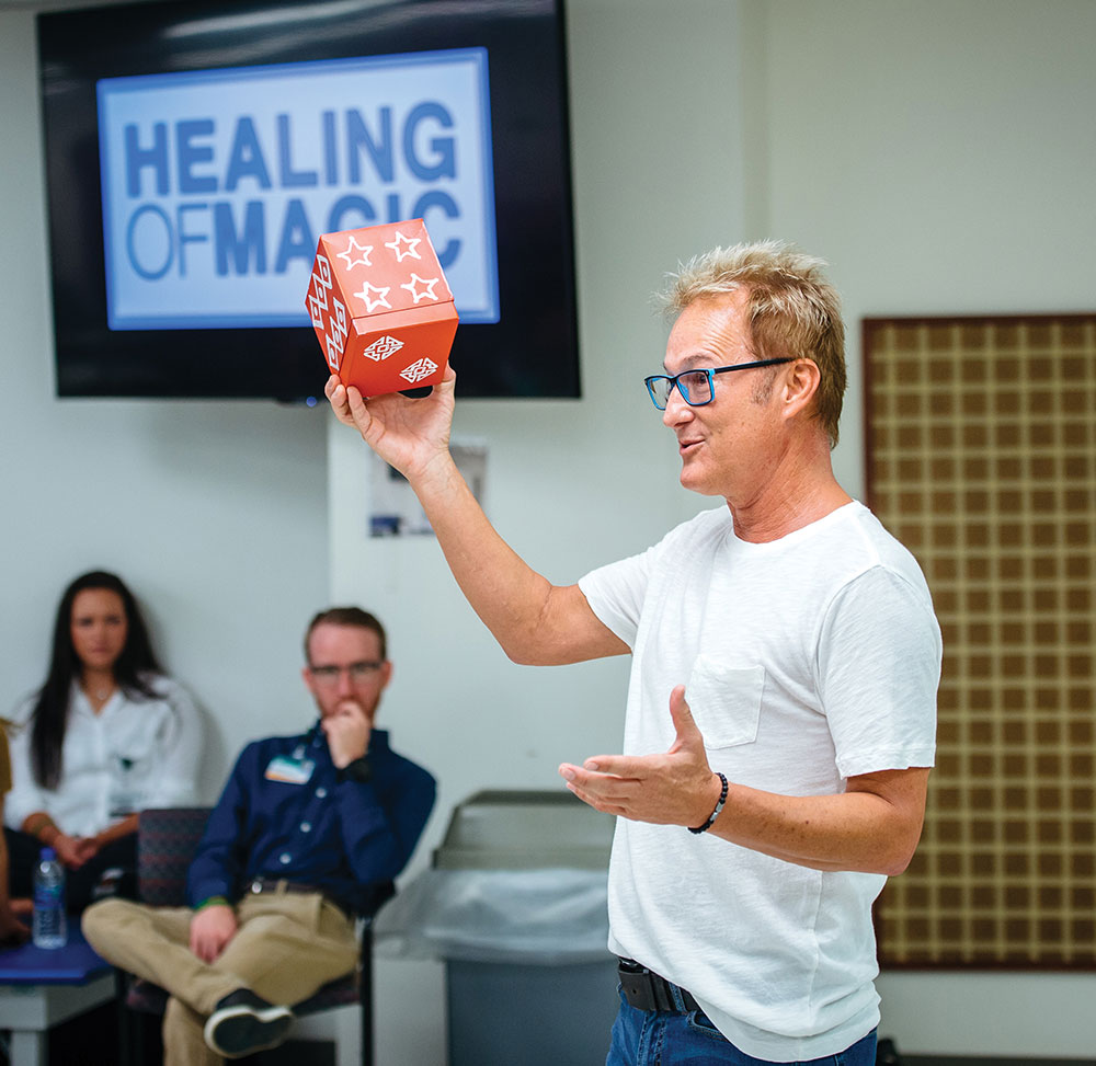 Photo of Kevin Spencer demonstrating magic trick for occupational therapy students
