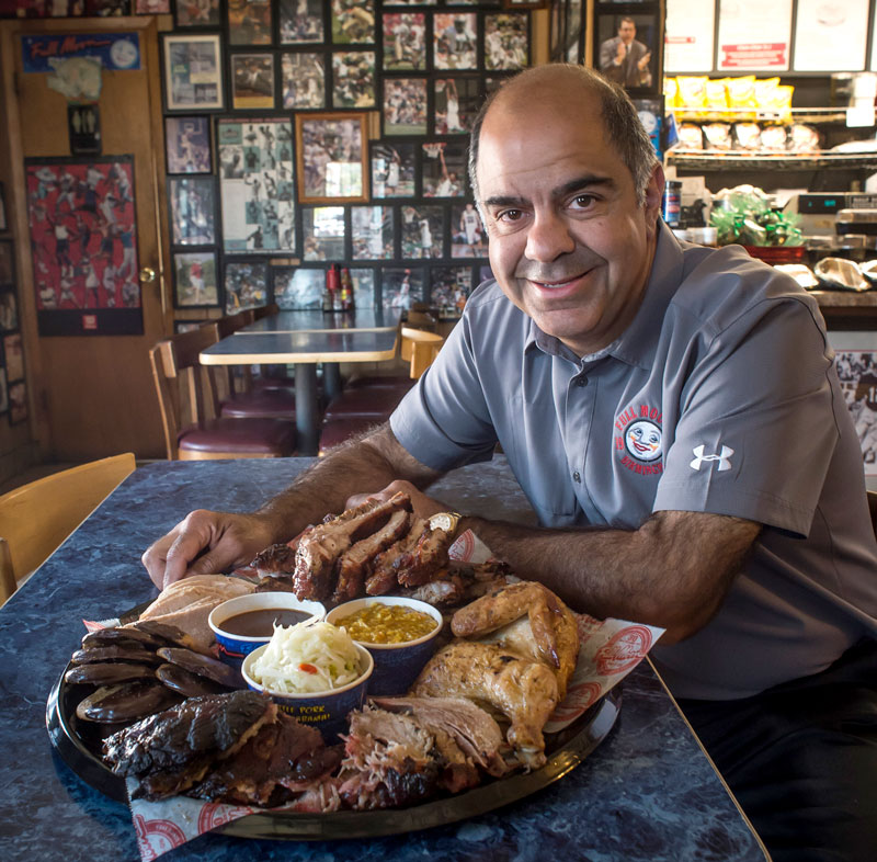 Photo of Joe Maluff with big plate of food at Full Moon Bar-B-Que