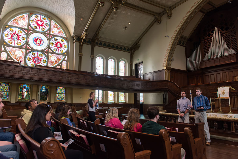Photo of tour leaders talking to group inside First Methodist Church