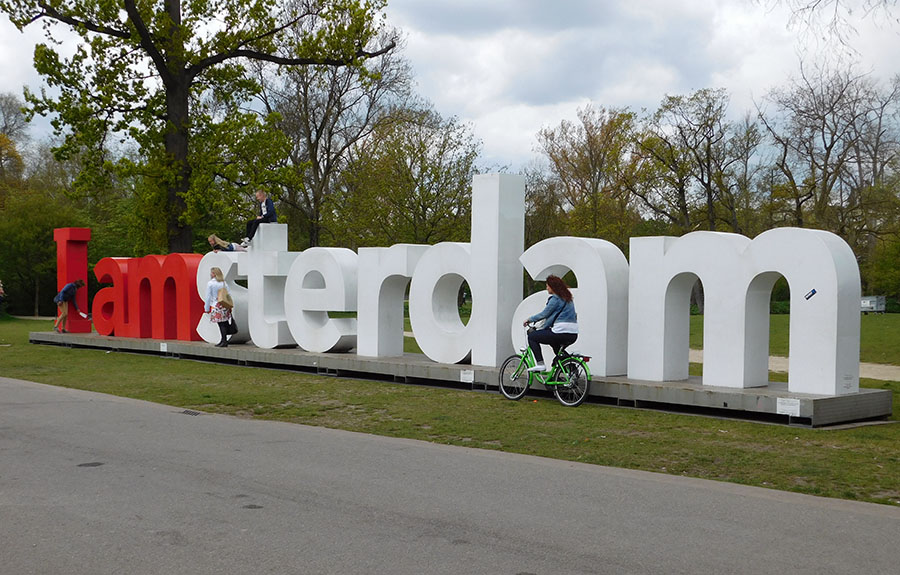 Photo of 'I am Amsterdam' sign with bicyclists