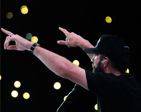 Photo of Sam Hunt performing with lights in background