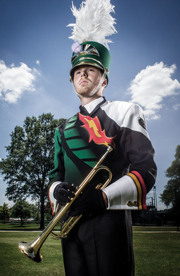 Photo of student wearing new band uniform and holding trumpet