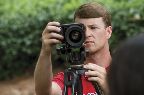 Photo of Matt Drummond working with video camera.