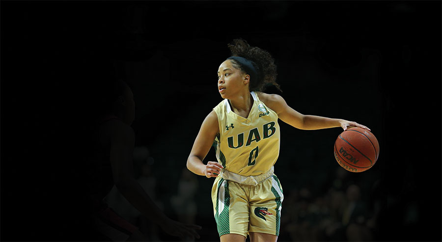 Photo of player Miyah Barnes dribbling the ball during a Bartow Arena game
