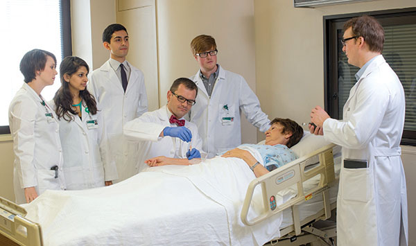 Photo of students and Younger with patient