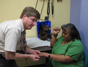 Dr Edward Lose visits with patient Ingrid Kidd