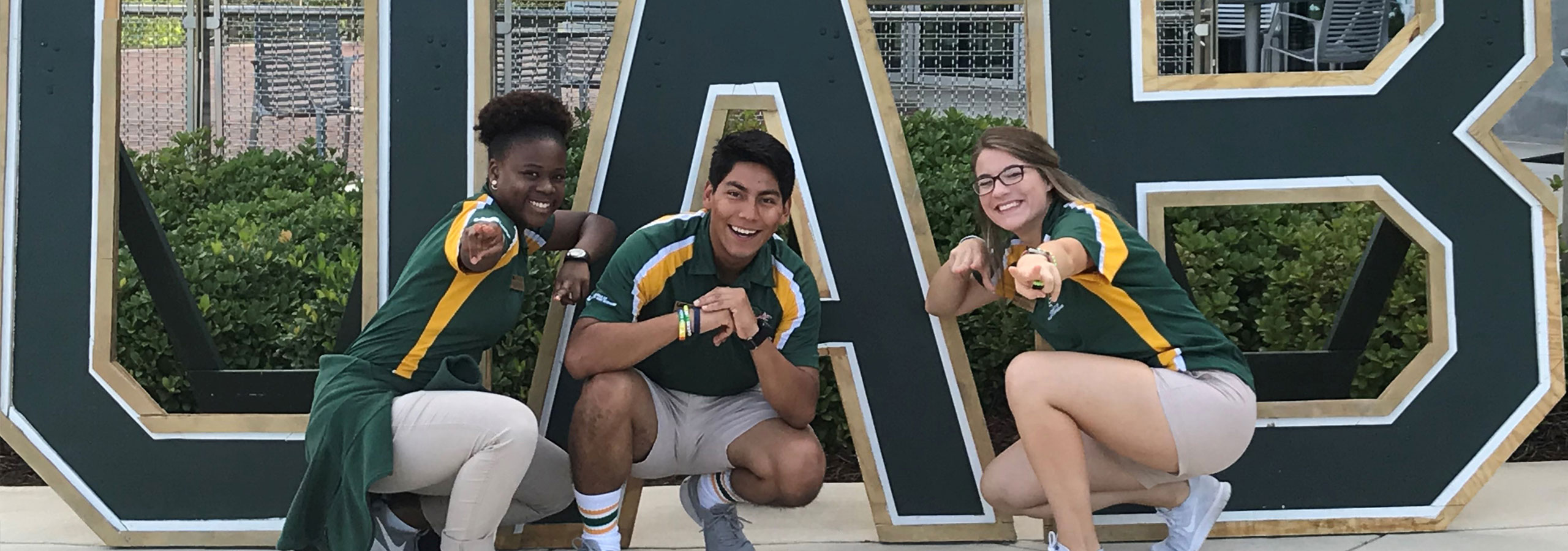 Students in front of a UAB sign.