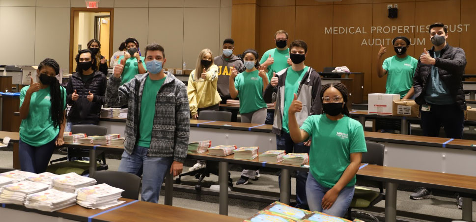 All of the Collat Scholars event volunteers, wearing facemasks and giving the thumbs-up sign.