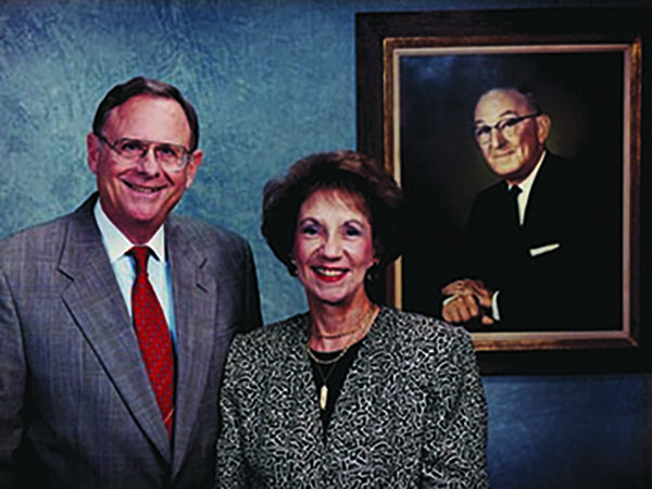 Charles and Patsy Collat with a portrait of Mayer Electric Founder Ben Weil, Patsy's father. 