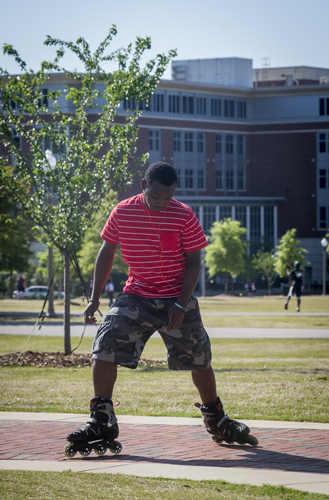 Student rollerblading on the UAB green.