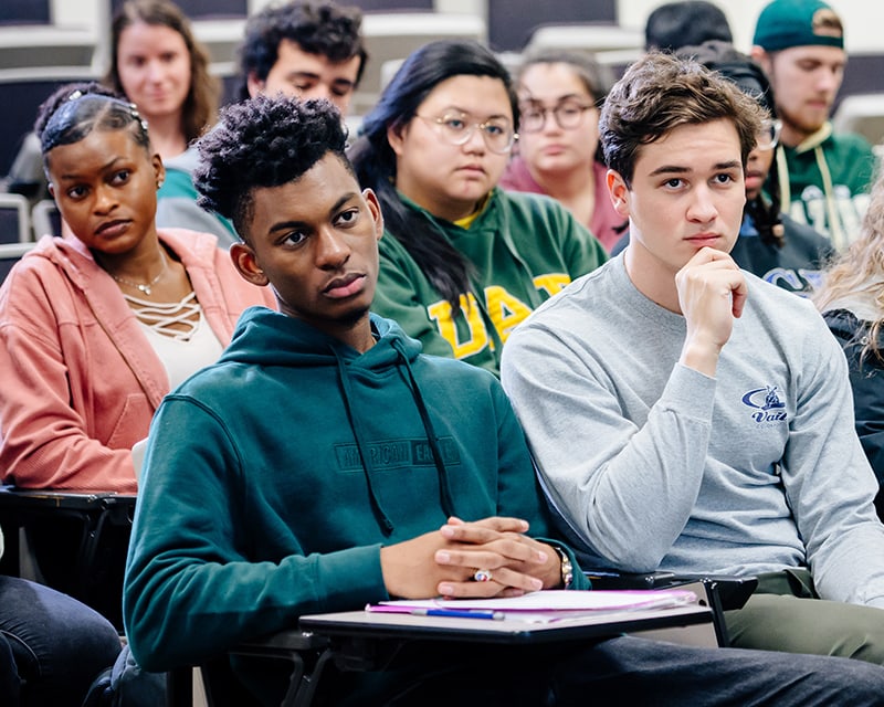 Students of multiple races and genders in a UAB classroom. 
