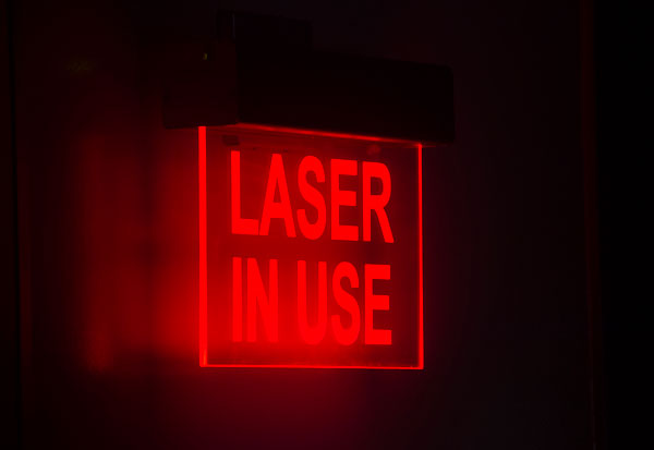 Lasers in use sign.