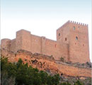 Part of the cover of the book, featuring a Spanish castle. 