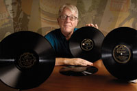 Andre Millard holding a vinyl record. 