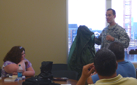 Captain Turner holding a parachute in the class. 