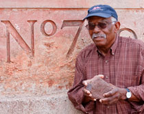 Ike Matson poses with the last piece of iron ore taken from mine No. 7 in 1962. He donated the piece to Red Mountain Park. Photo: Eric McFerrin/Red Mountain Park