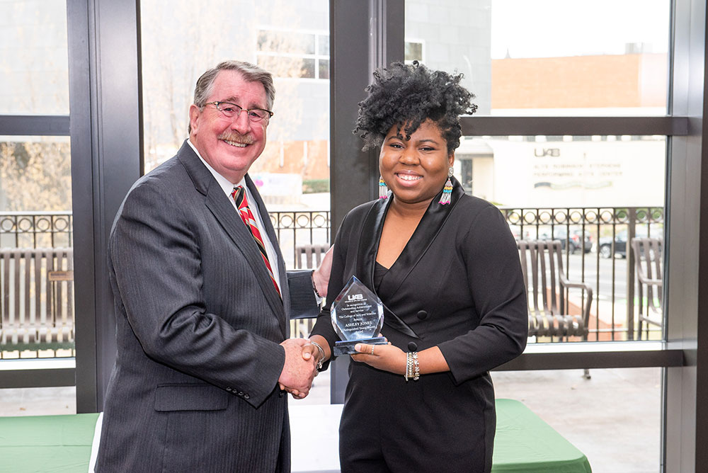 Dean Palazzo congratulating Ashley M. Jones.