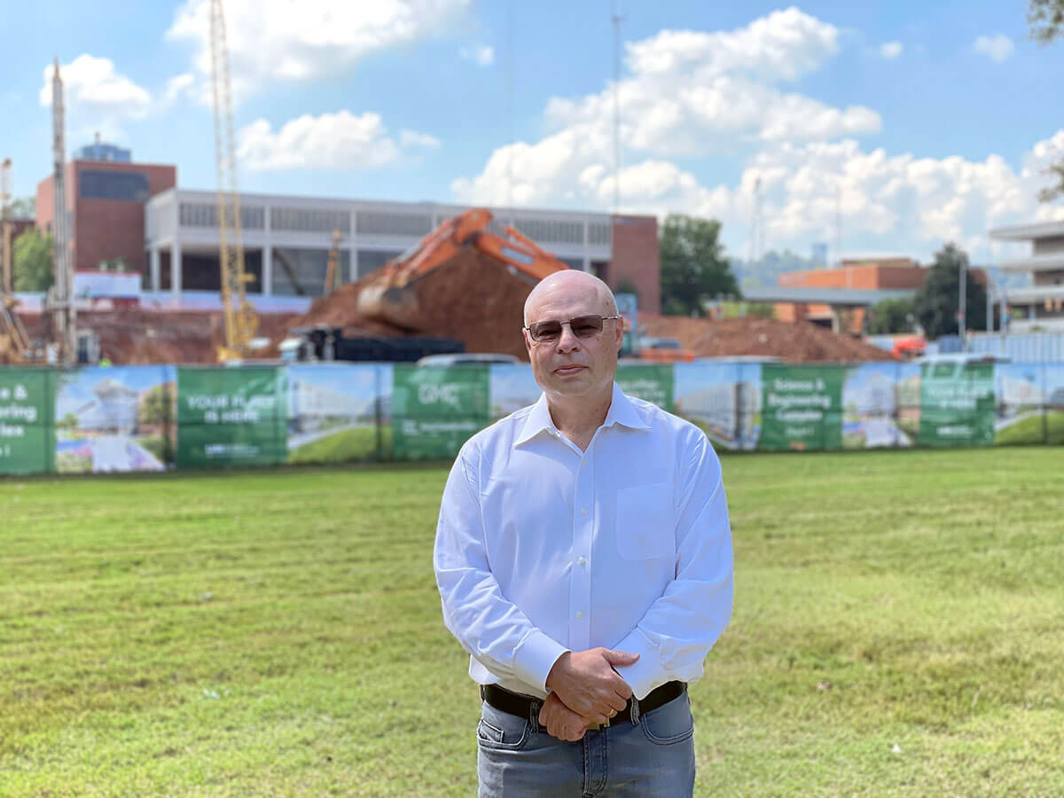 Sergie Mirov standing at the construction site of the new building. 
